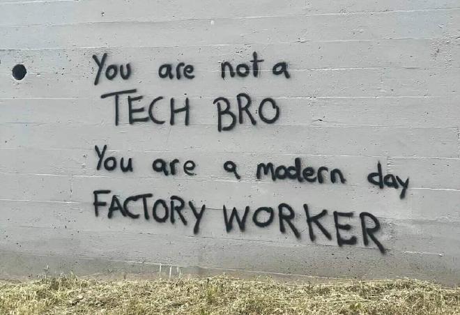 Radical graffiti stating ‘you are not a tech bro you are a modern day factory worker’